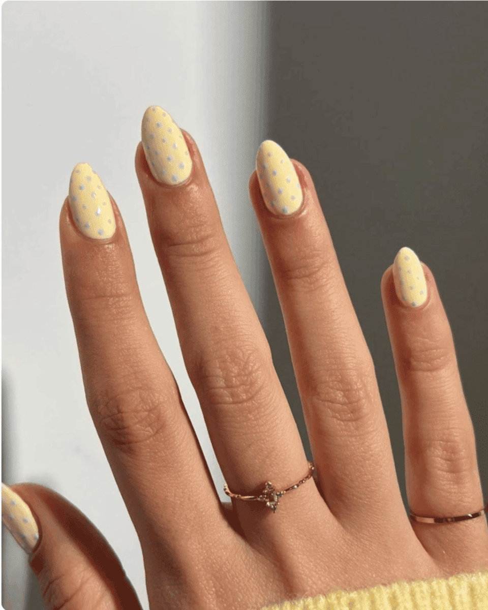 butter yellow nails with blue polka dots on short round almond nails spring 2026