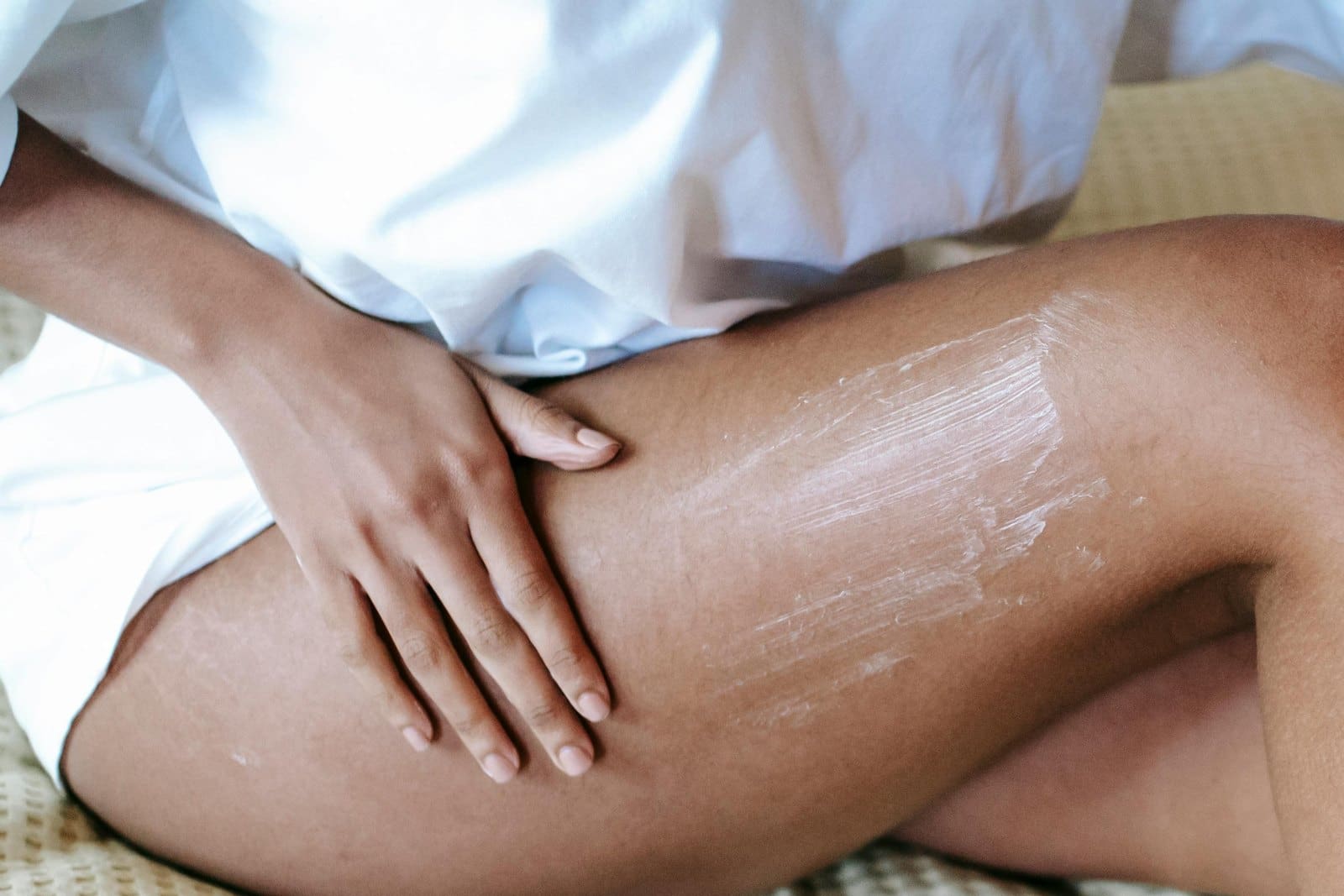 Applying moisturizer to a leg for smooth, even skin