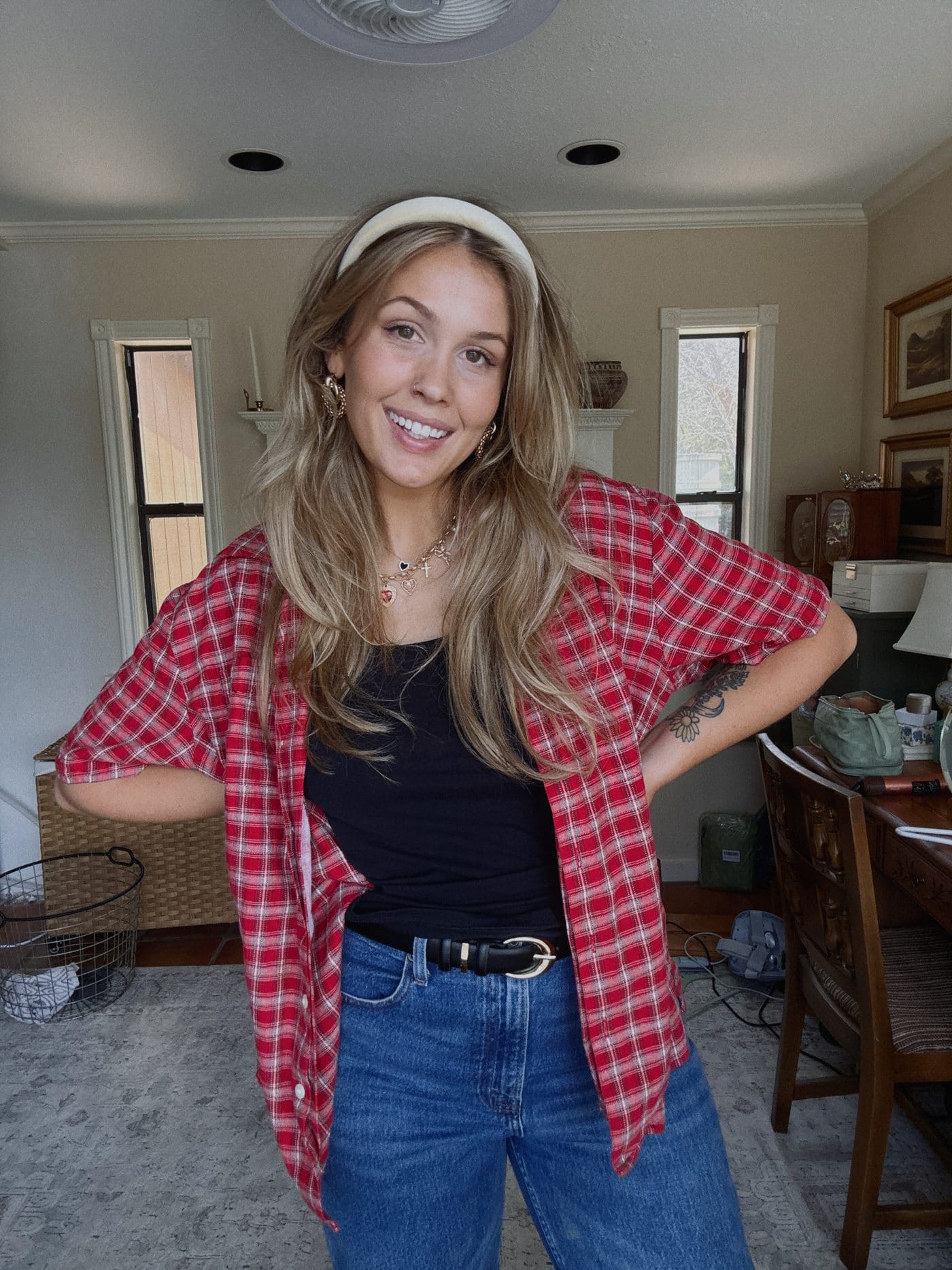 Red plaid button-up shirt styled with jeans and a headband
