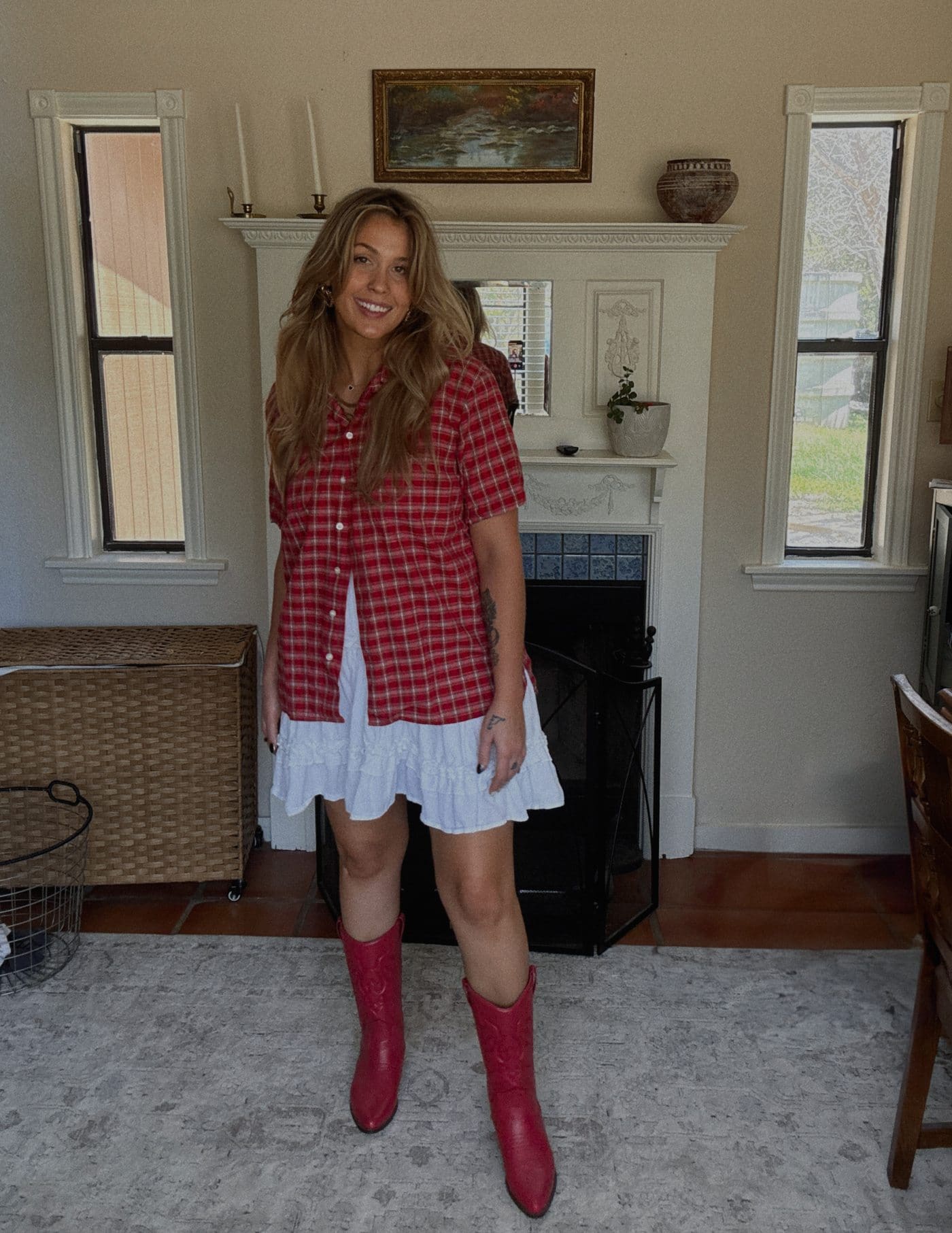 Red plaid button-up over a white dress with cowboy boots