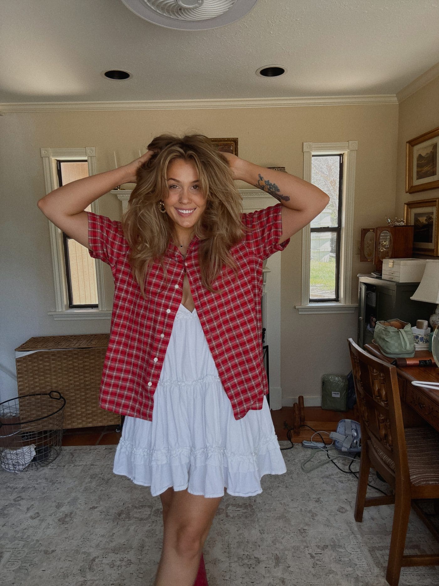 Red plaid button-up layered open over a white sundress