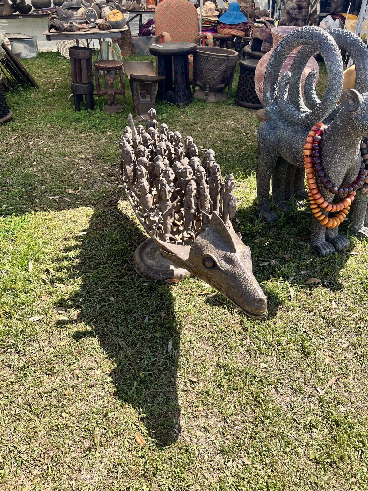 Metal animal sculptures with beaded necklaces in the grass at the Warrenton fields at Round Top