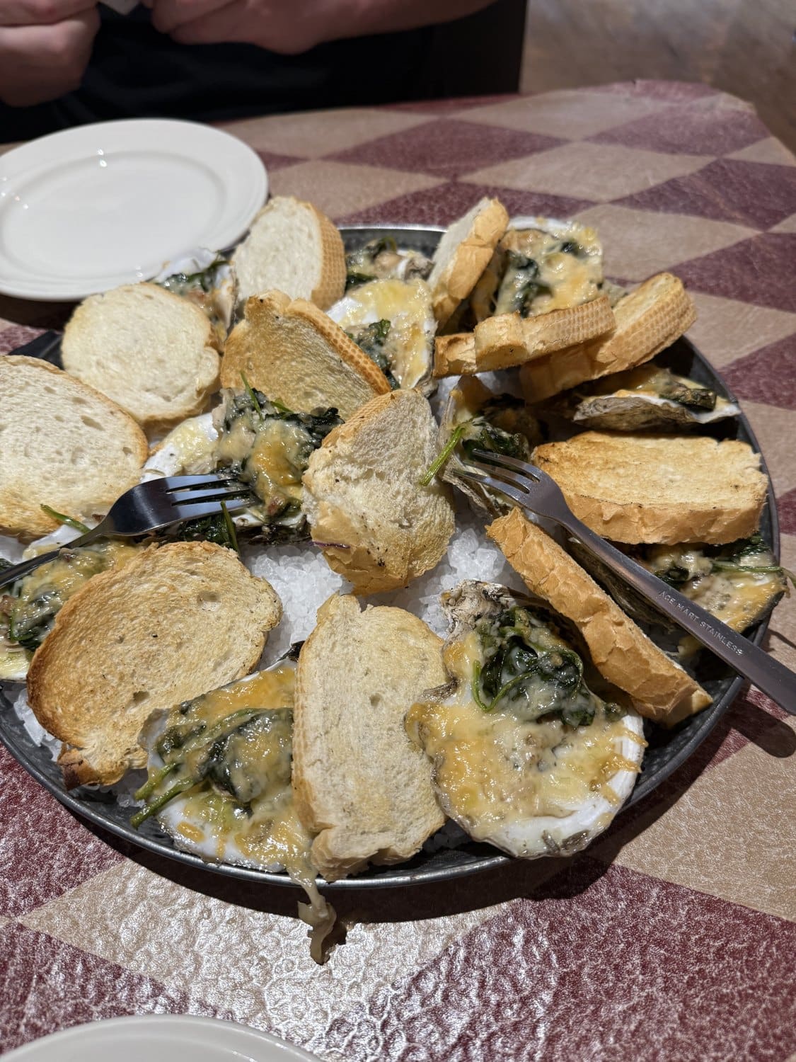 A baked seafood appetizer with crostini at Wahoo
